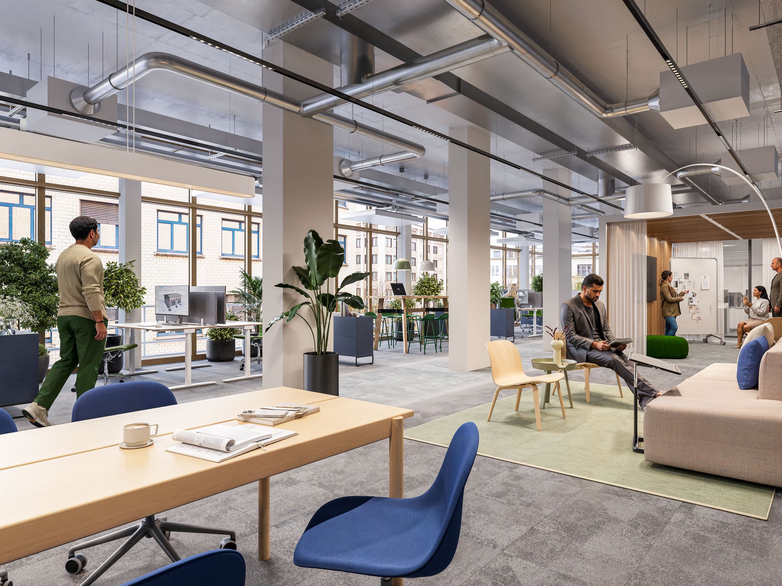 Ansicht einer offenen und modernen Arbeitsumgebung mit Arbeitsplätzen und Sitzplätzen im Gebäude FLOW im Neuen Klybeck in Basel